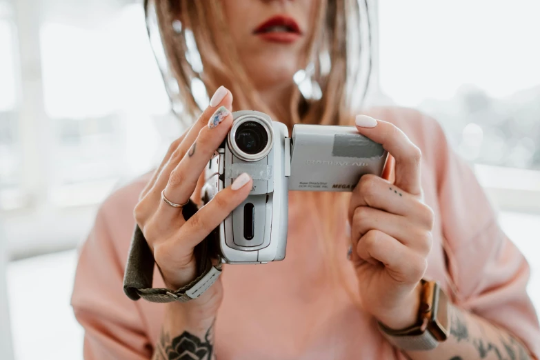 woman taking pograph with camera while in dress