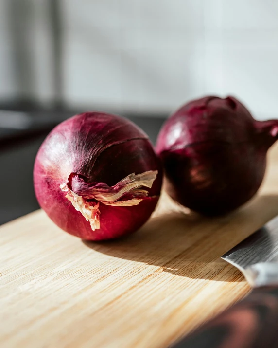 two pieces of red onions on a  board