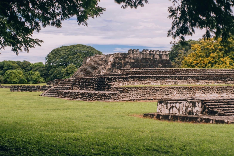 an image of an ancient structure in the grass