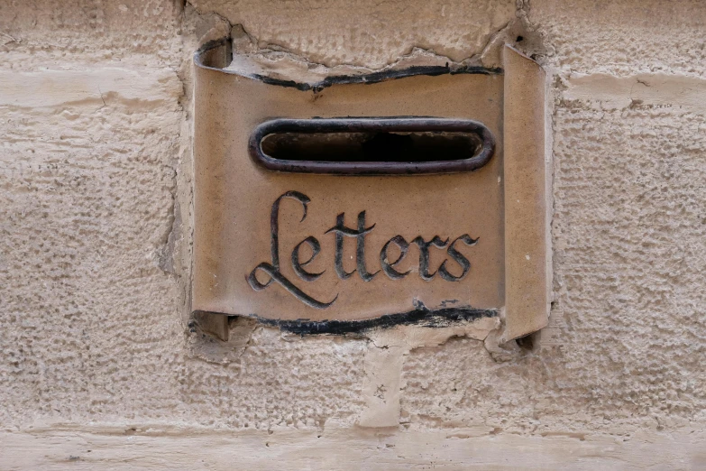 a window with letters on it hanging off of the wall