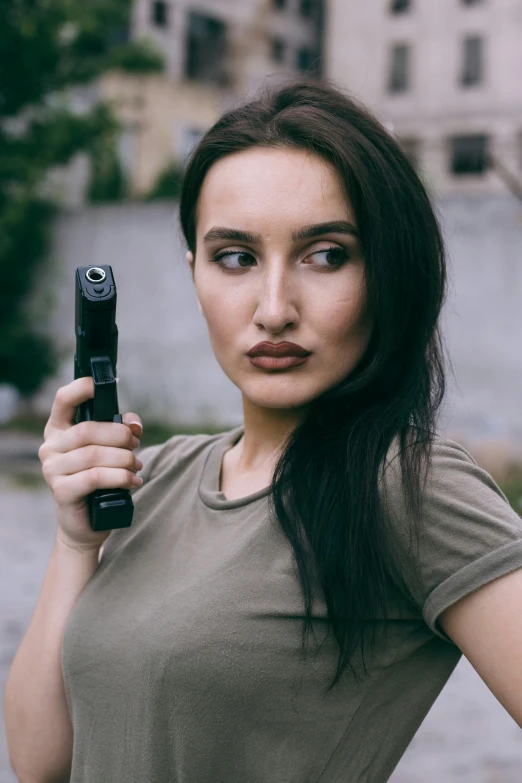 a woman with very long brown hair holding up a cell phone