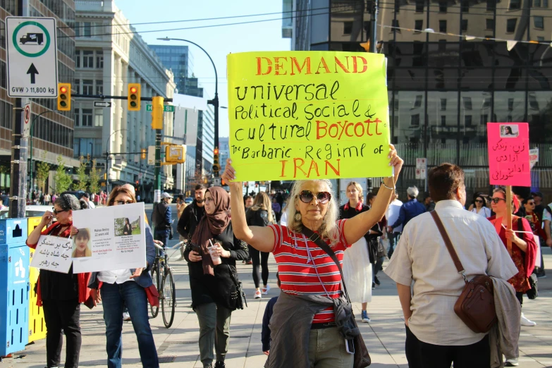 a person holding a sign with several other people