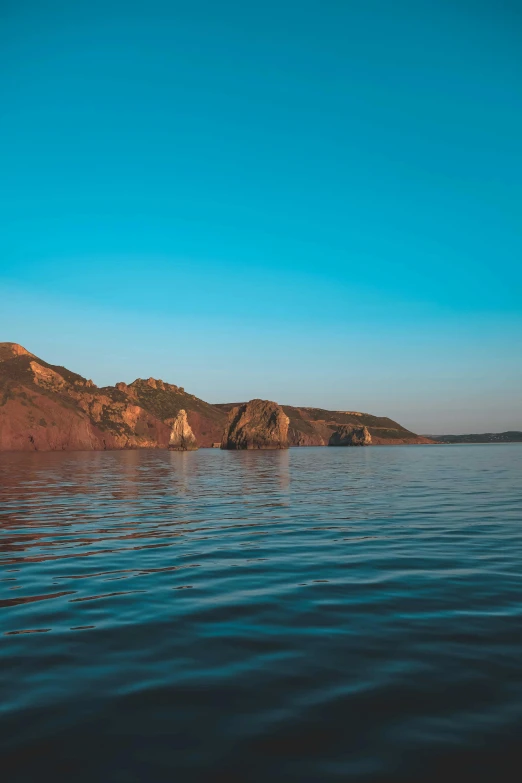 the sky is a brilliant color over water