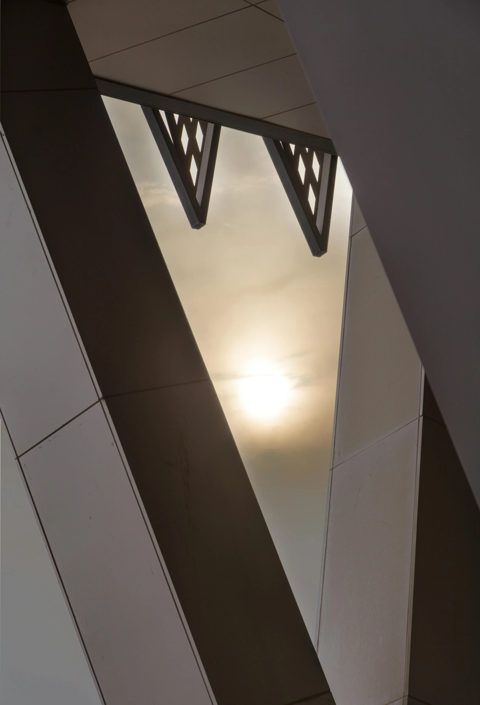 a building is seen from below in a mirror