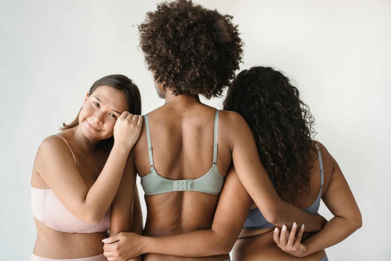 a woman wearing a  looks at another woman's back