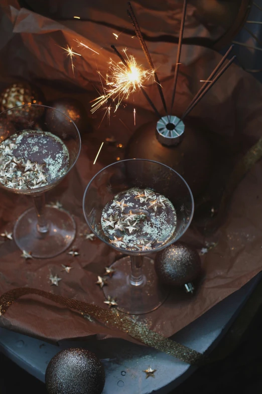 three goblets and a sparkler in the middle