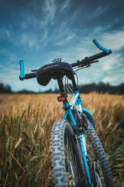 a bike in front of a blue and green sky