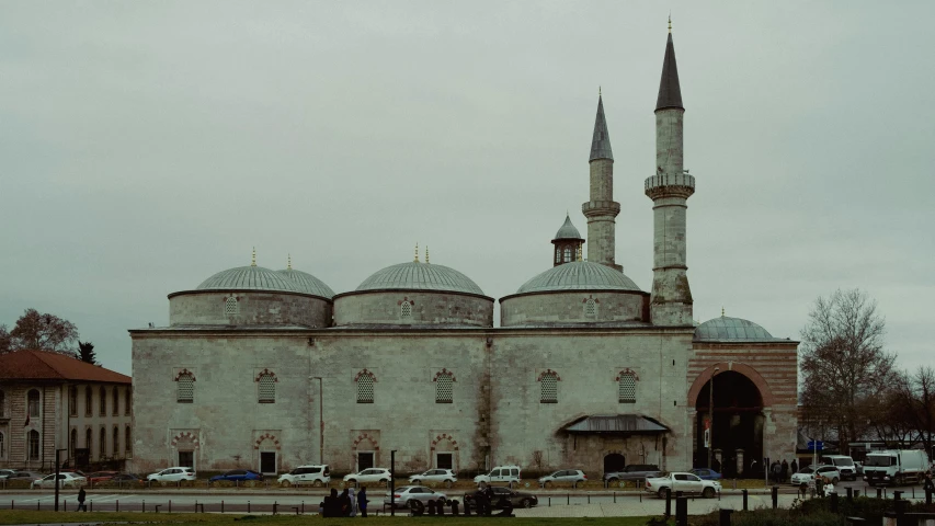 a large building with two minalis in front