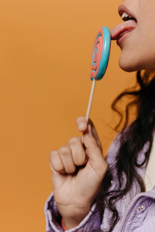 a young woman taking a bite of a tooth brush