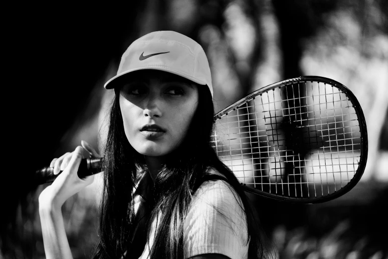 a tennis player is posing with her racket in his hands