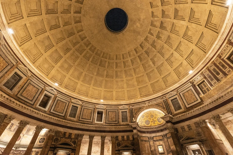 the inside dome of a building with columns and a clock