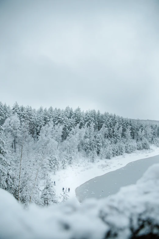 some people walking up the side of a mountain covered in snow