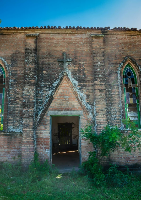 old brick church wall with a door leading to it