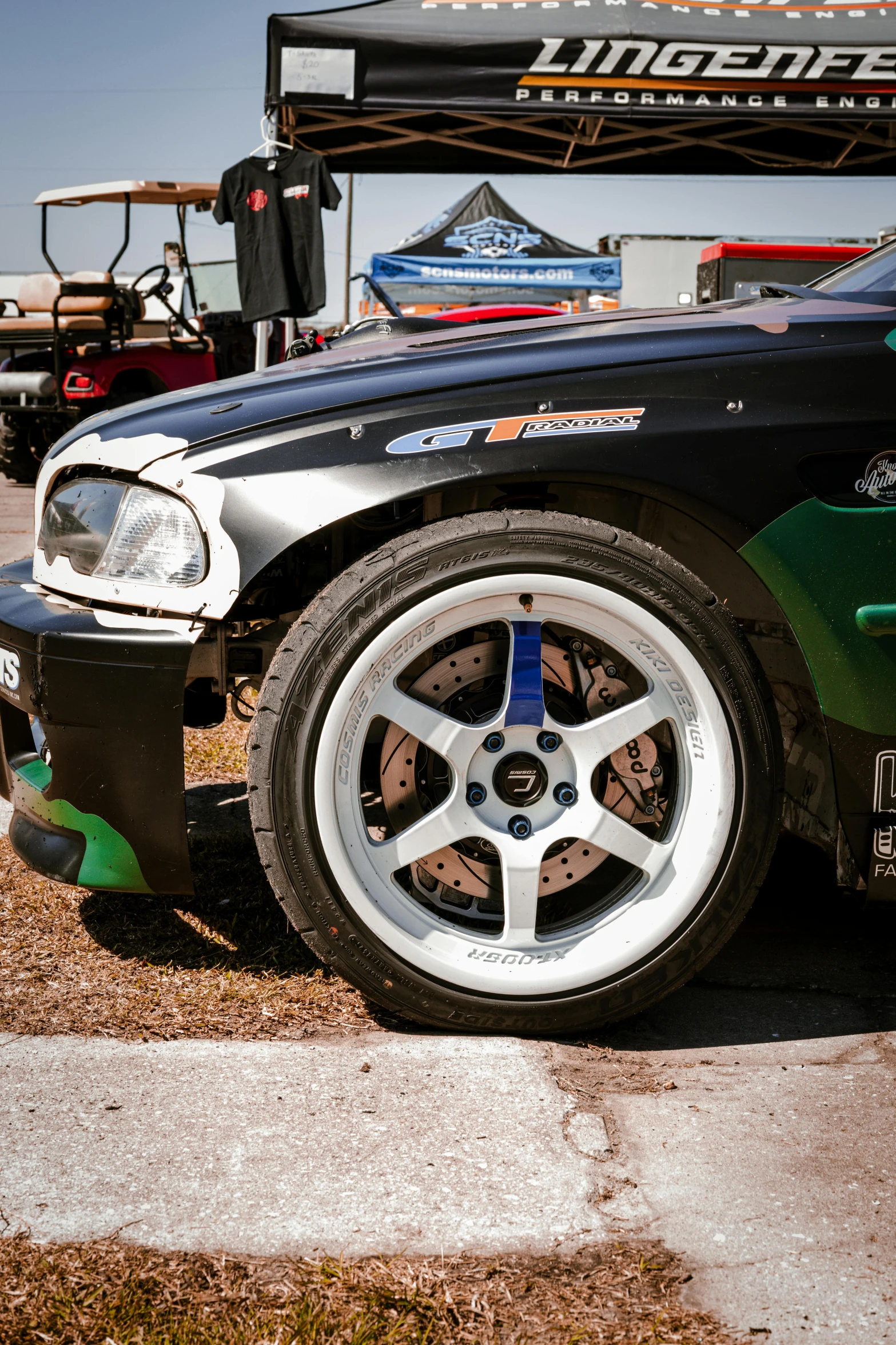 a car parked at the side of the road, and its tires up