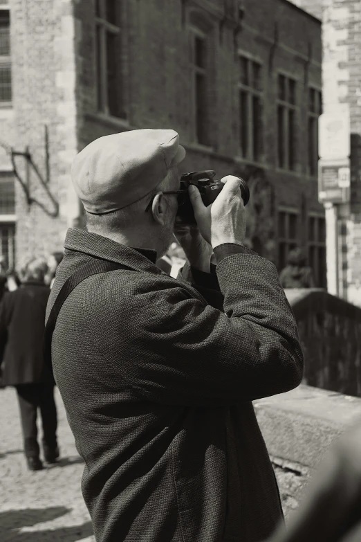 a man wearing a hat is looking into the distance