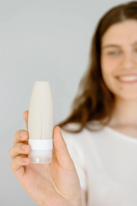 woman showing a plastic tube in front of her