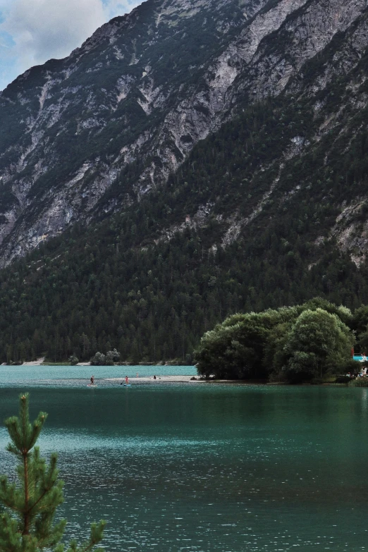 a sail boat sitting in the middle of the water