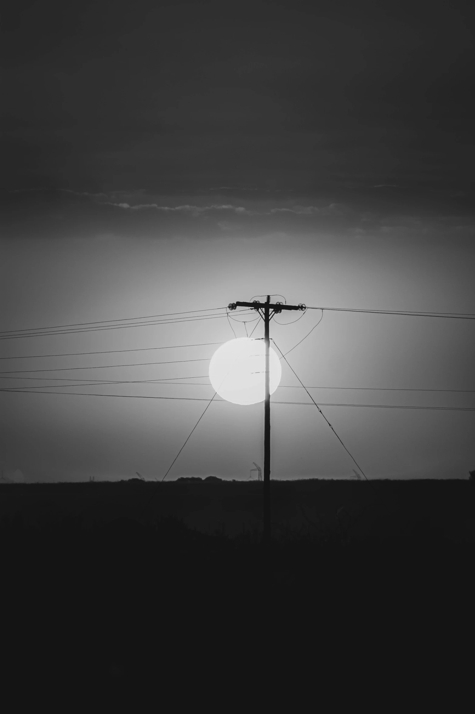 the sun is setting over a black and white po