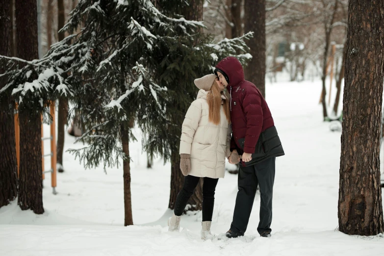 a couple kissing each other in the woods