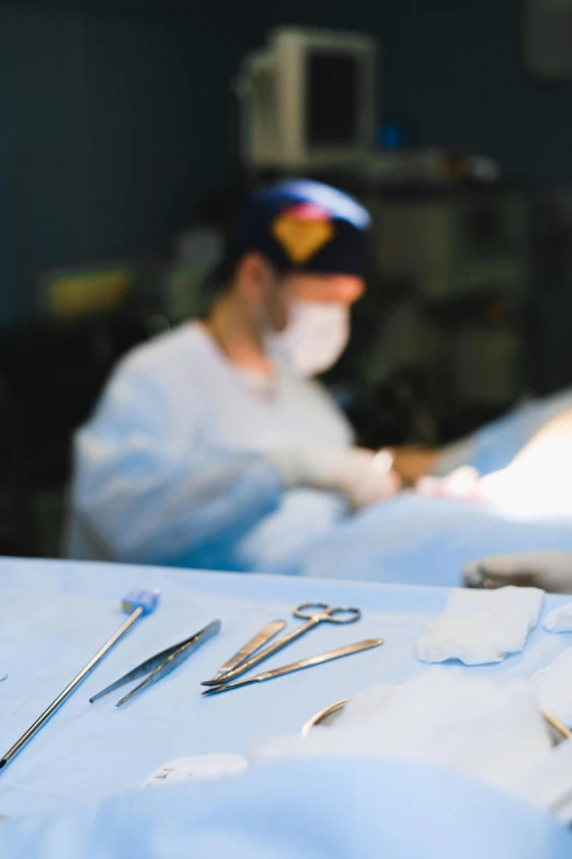 doctors wearing masks while looking over some surgical items