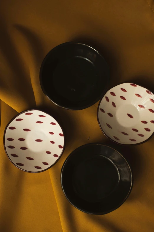 three bowls sit in the middle of a yellow table cloth