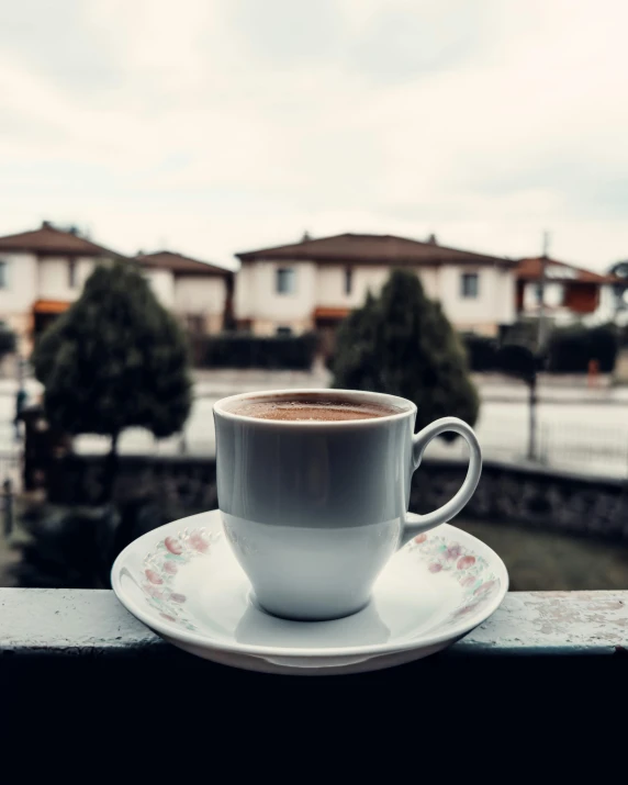 a cup of coffee is sitting on a ledge