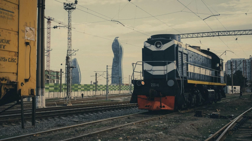 a passenger train on a track near buildings