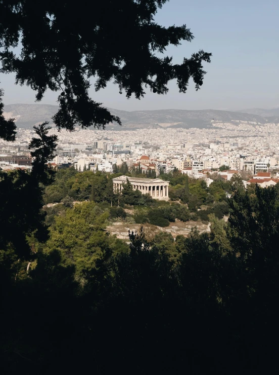 city from hills with building, trees and sky