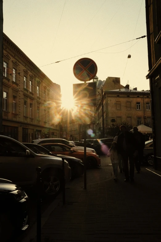 a street in the evening is covered in cars