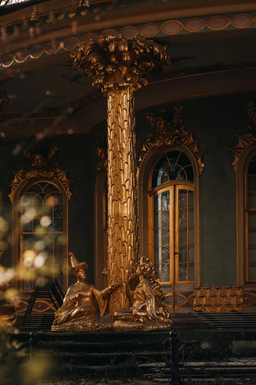 a gilded room with ornate gilded furniture and windows