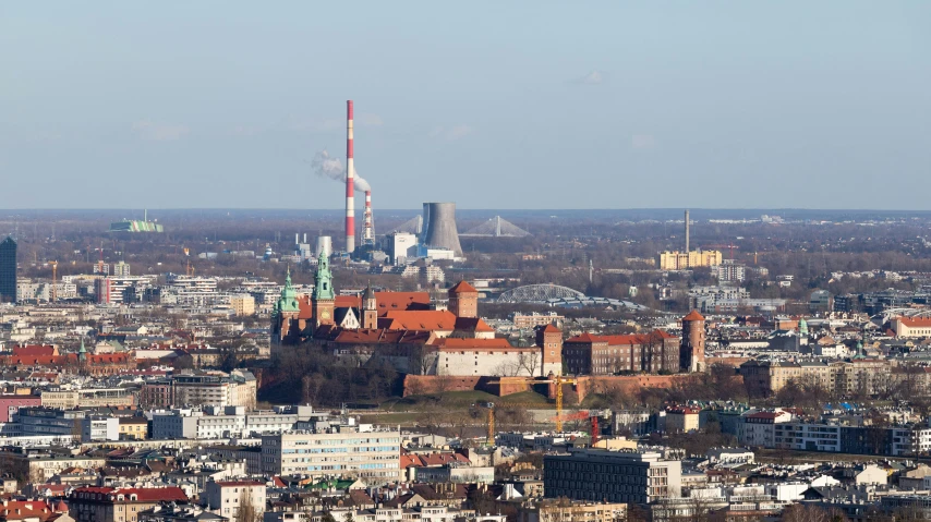 a city with a few buildings and smokestacks