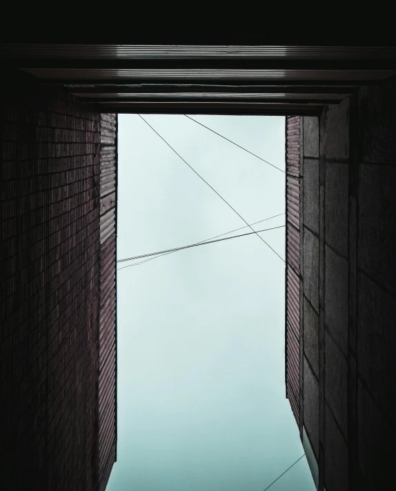 a wall is shown looking up and leaving wires above