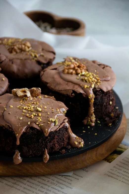 two pieces of cake are on the plate with brown icing