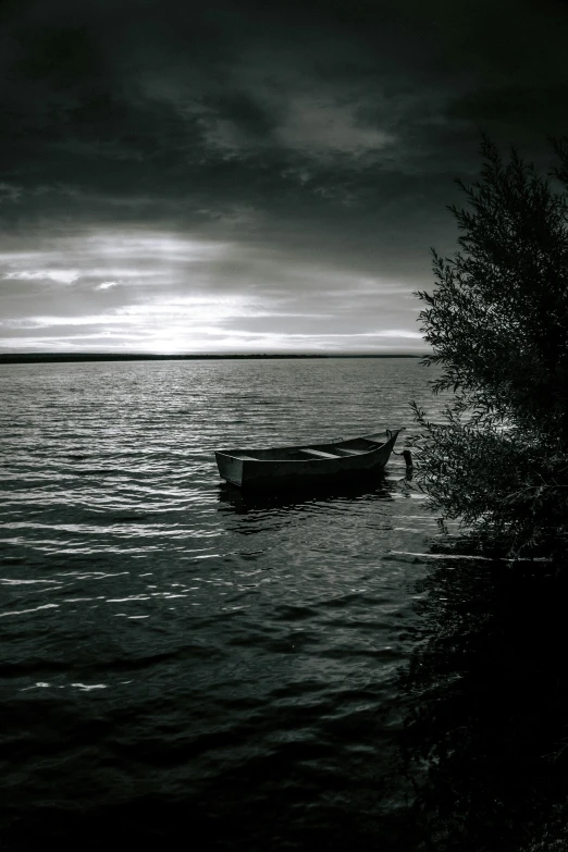 a boat is out on the water with a black and white background