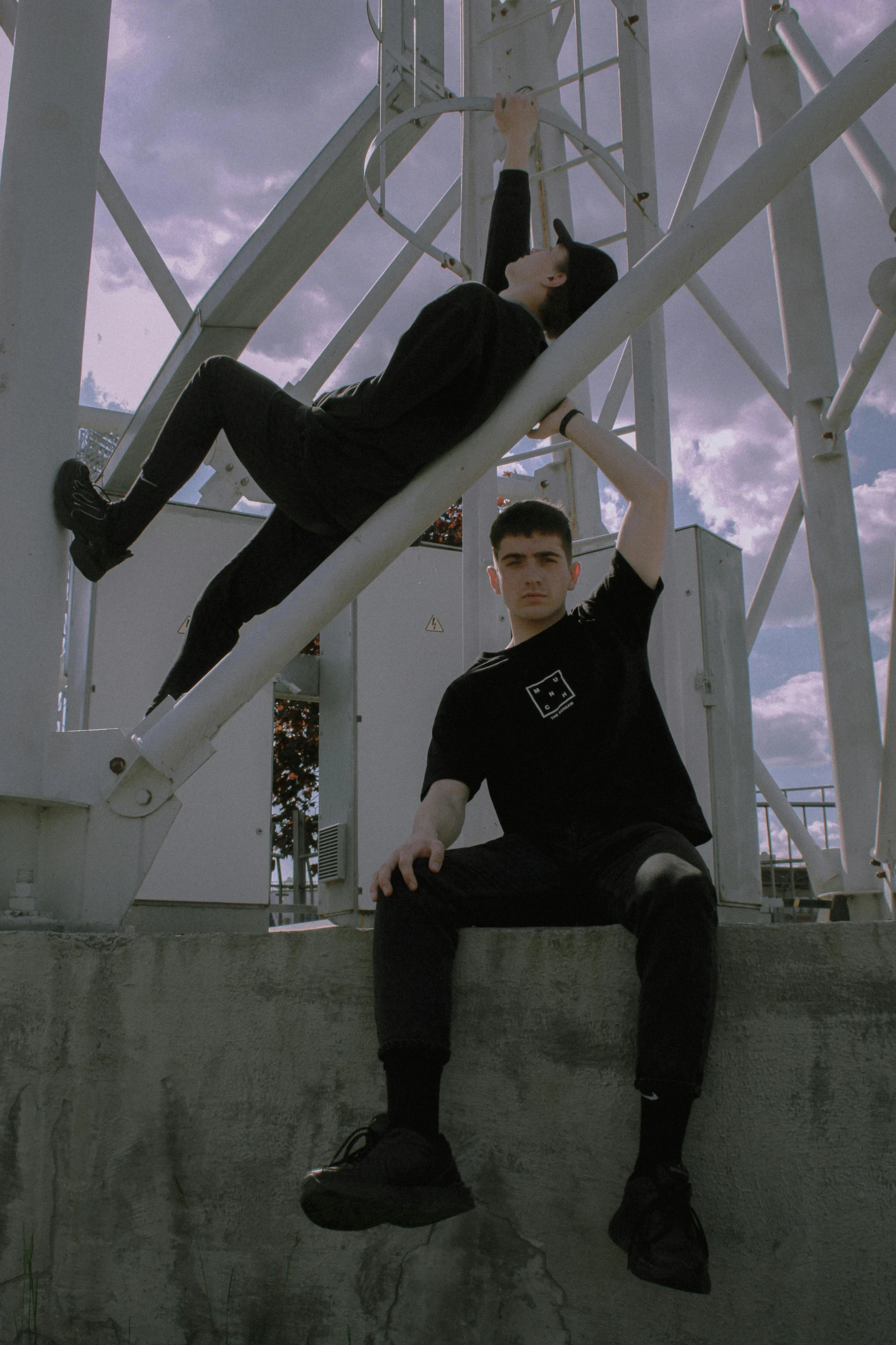 two men posing for a picture under a building