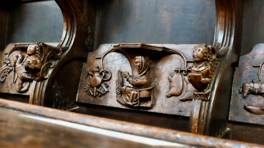 ornate wooden carvings depicting elephants and lions in an antique woodwork