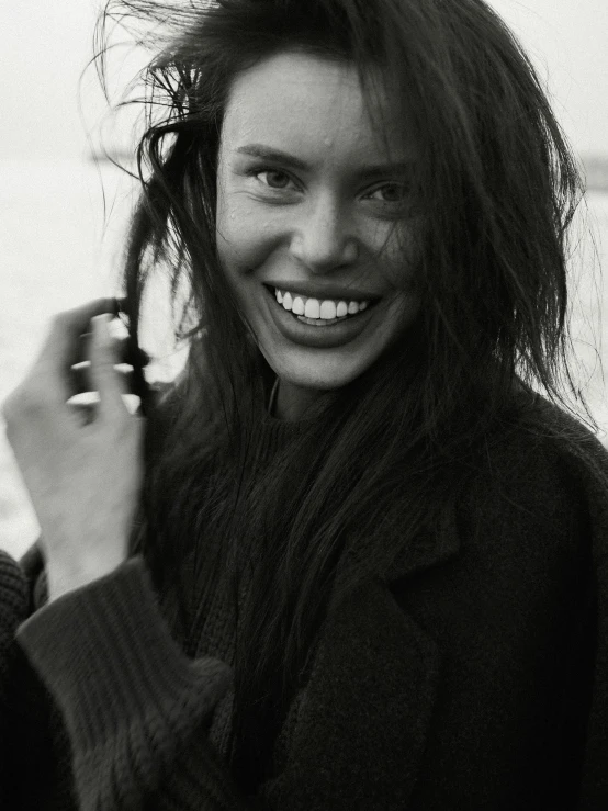 a woman smiles while talking on the phone