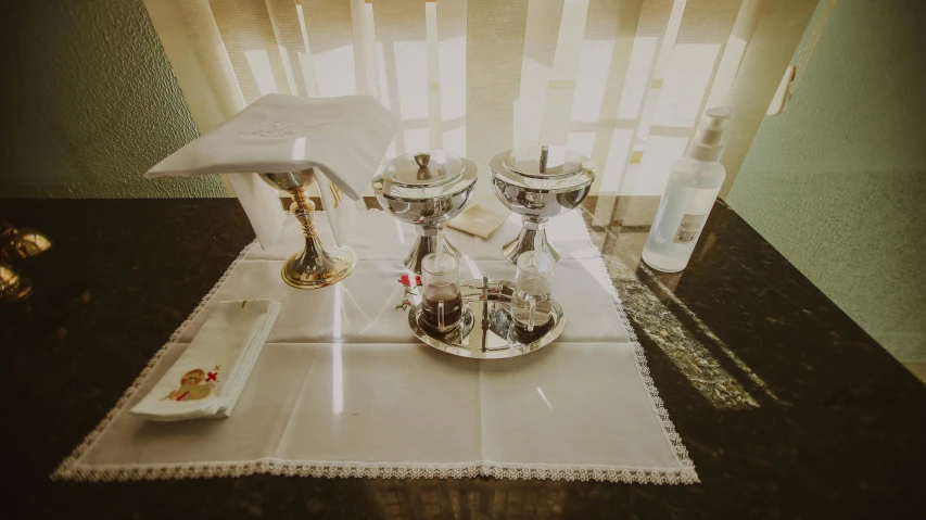 there is an empty tray with silver cups and a white umbrella