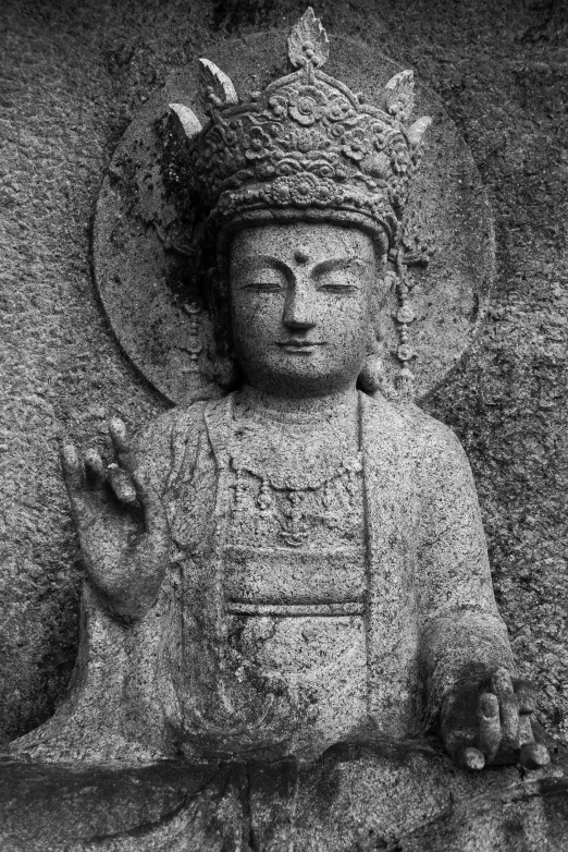 a statue of a buddha is in black and white