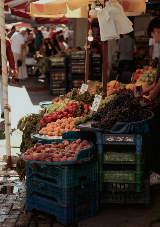 an outside market with baskets and produce on the tables