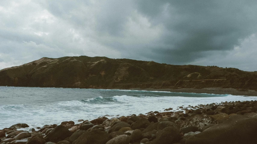 there are rocky shore with water at the bottom