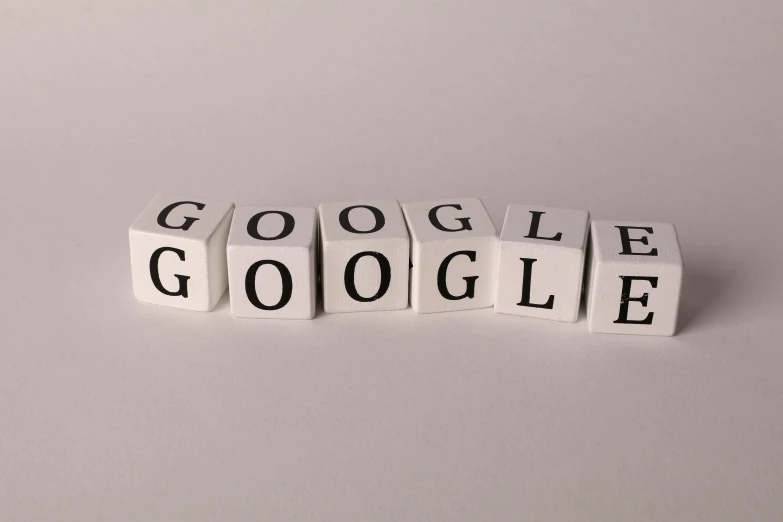 three white blocks spelling the word google on a gray background