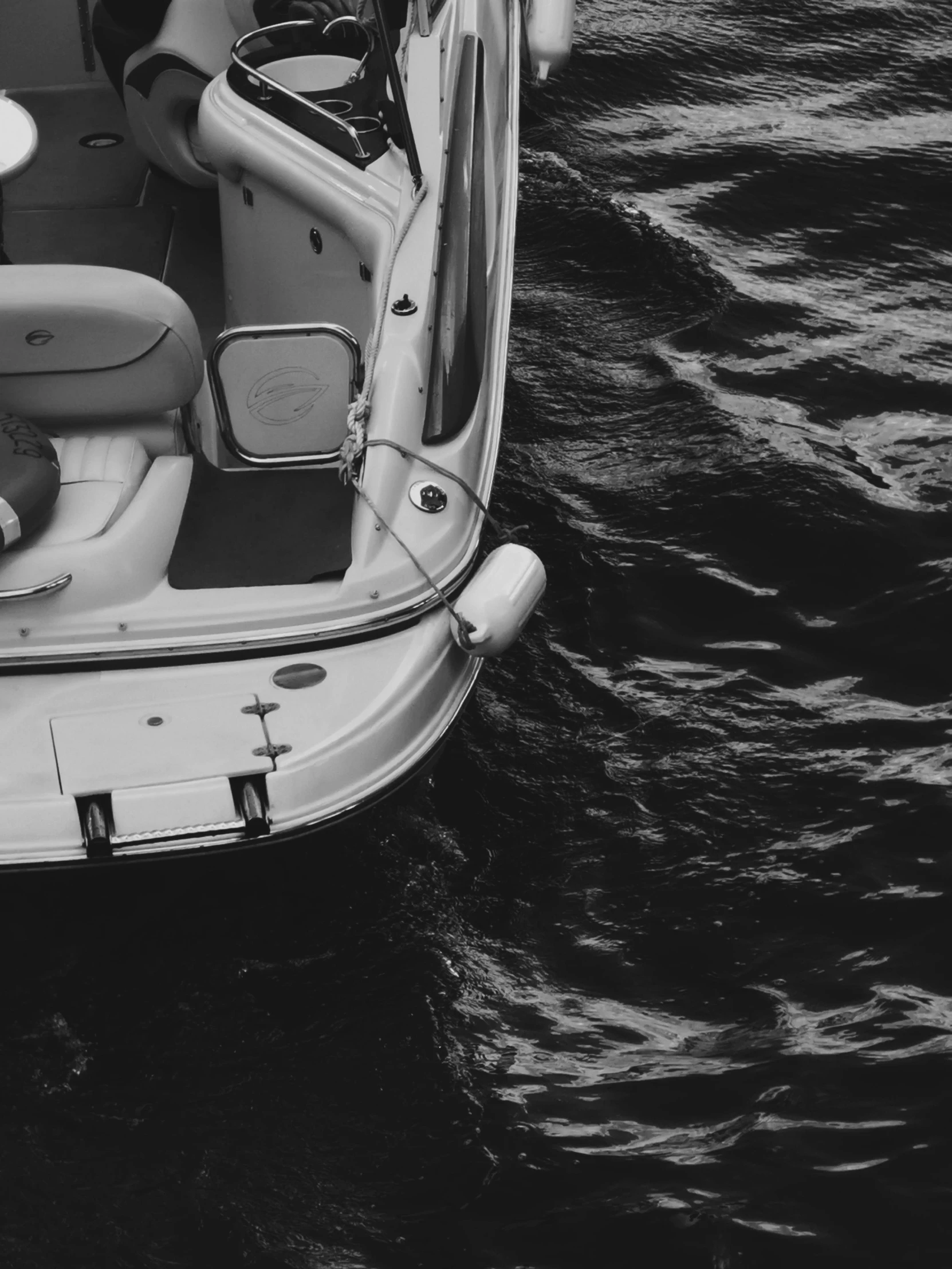 a white boat sitting on top of the ocean next to a smaller boat