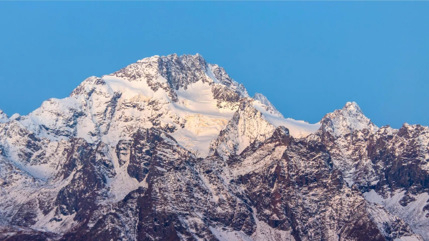 a large mountain is covered in snow