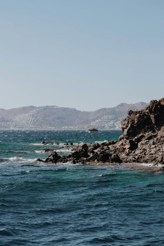 a large body of water with mountains in the background