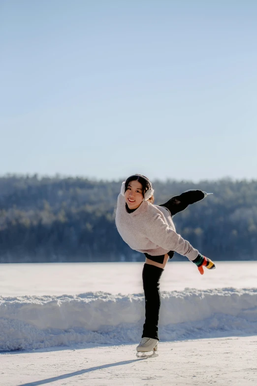 woman with skateboard making a flip in the snow