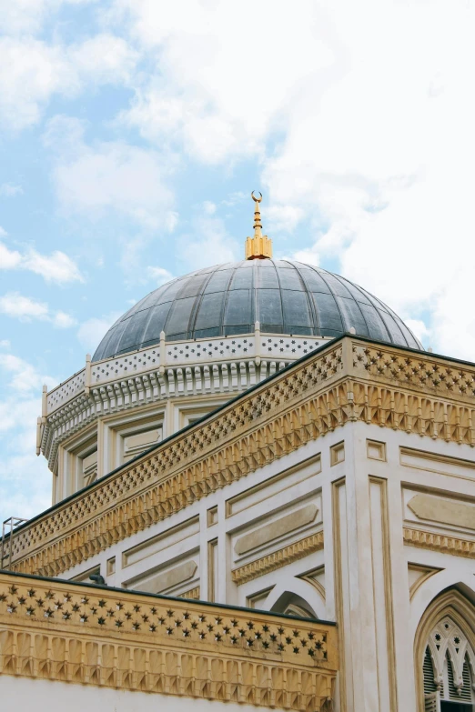 a view of a tall white building with a dome