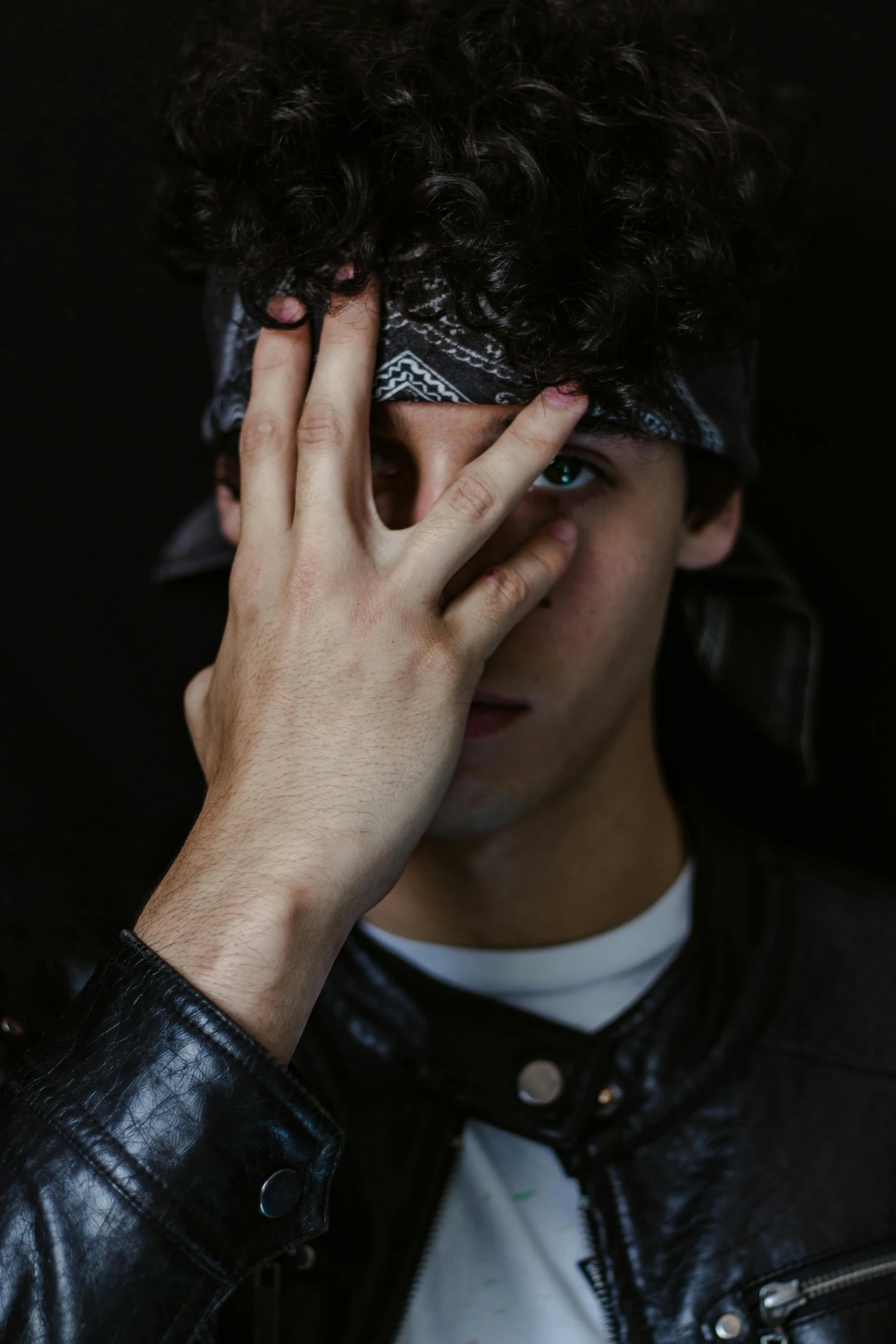 a man covering his eyes with his hands