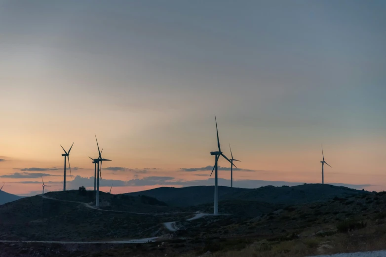 there are some windmills on the side of a mountain