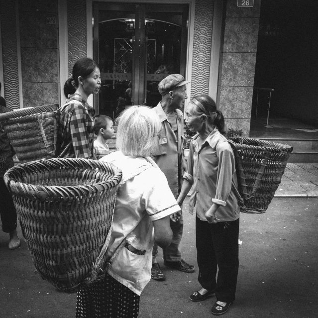 several people are gathered outside an old building in an alley